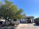 Charming single-story home with a lovely red-tiled roof, mature tree, and an inviting carport at 1731 Paloma Ave, Laughlin, NV 89029