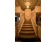 Impressive two-story foyer with dual staircase and striking chandelier at 2200 Purple Majesty Ct, Las Vegas, NV 89117