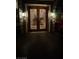 Elegant front door with custom glass and sconce lighting provides a stunning entry at 2200 Purple Majesty Ct, Las Vegas, NV 89117