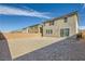 View of a large backyard featuring a neutral-toned home and a sliding glass door at 2705 Cava Tirreni St, Henderson, NV 89044