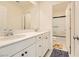 Bright bathroom featuring double sinks, white cabinets, and a convenient shower over tub setup at 2705 Cava Tirreni St, Henderson, NV 89044