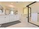 Bright bathroom featuring double sinks, soaking tub, and glass enclosed shower at 2705 Cava Tirreni St, Henderson, NV 89044