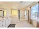 Bright bathroom featuring double sinks, soaking tub, and glass enclosed shower at 2705 Cava Tirreni St, Henderson, NV 89044