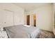 Well-lit bedroom with a view to the bathroom area, closet with sliding doors, and soft carpet at 2705 Cava Tirreni St, Henderson, NV 89044