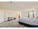 Expansive carpeted bedroom with an additional space, bright windows, and neutral walls at 2705 Cava Tirreni St, Henderson, NV 89044