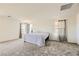 Spacious carpeted bedroom with bright windows, neutral walls, and comfortable accommodations at 2705 Cava Tirreni St, Henderson, NV 89044