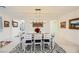 Well-lit dining room with modern light fixture and a large dining table at 2705 Cava Tirreni St, Henderson, NV 89044