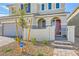 Inviting home entrance with a red door, small gated courtyard, and manicured landscaping at 2705 Cava Tirreni St, Henderson, NV 89044