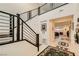 Modern staircase foyer with an open railing design, tile floors, and plenty of natural light at 2705 Cava Tirreni St, Henderson, NV 89044