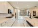 Modern kitchen featuring white cabinets, marble countertops, and stainless steel appliances at 2705 Cava Tirreni St, Henderson, NV 89044