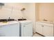 Bright laundry room featuring a utility sink, washer, and dryer at 2705 Cava Tirreni St, Henderson, NV 89044