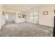 Spacious living room with carpet and natural light from two windows with curtains at 2705 Cava Tirreni St, Henderson, NV 89044