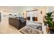 Bright living room and kitchen area with tile flooring and contemporary furnishings at 2705 Cava Tirreni St, Henderson, NV 89044