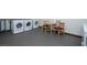 Shared laundry facility with two washers, a table and chairs, and a dryer at 223 Hunter Ridge Rd # A202, Brian Head, UT 84719