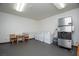 Community laundry room with multiple washers, dryers, and a small table at 223 Hunter Ridge Rd # A202, Brian Head, UT 84719