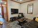 Cozy living room features a leather sofa, large TV, and a comfortable armchair at 223 Hunter Ridge Rd # A202, Brian Head, UT 84719