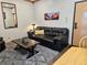 Living room with a leather sofa, coffee table, and a large artwork on the wall at 223 Hunter Ridge Rd # A202, Brian Head, UT 84719