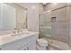 Modern bathroom with white vanity, shower, and toilet at 7151 Serene Creek St, Las Vegas, NV 89131