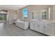 Elegant bathroom with double sinks and a soaking tub at 7151 Serene Creek St, Las Vegas, NV 89131