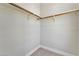 Empty closet with wooden shelves and rods at 7151 Serene Creek St, Las Vegas, NV 89131