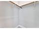 Empty closet with wooden shelves and rods at 7151 Serene Creek St, Las Vegas, NV 89131