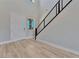 Modern entryway with light wood floors and a staircase at 7151 Serene Creek St, Las Vegas, NV 89131