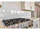 Stainless steel gas cooktop and white shaker cabinets in a modern kitchen at 7151 Serene Creek St, Las Vegas, NV 89131