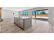 Open kitchen with island, stainless steel appliances, and sliding door to backyard at 7151 Serene Creek St, Las Vegas, NV 89131