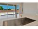 Modern kitchen sink and faucet with a view of the backyard at 7151 Serene Creek St, Las Vegas, NV 89131