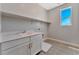 Laundry room with white cabinets and a utility sink at 7151 Serene Creek St, Las Vegas, NV 89131