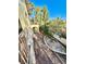 Balcony view overlooking backyard, with stone and concrete landscaping and mature trees and shrubs at 2089 Avalon Dr, Laughlin, NV 89029