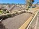 Backyard has gravel, block wall fence and a patio view from the top floor balcony at 2089 Avalon Dr, Laughlin, NV 89029