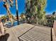 Balcony overlooking palm trees, swimming pool, and lush greenery with a sturdy metal railing at 2089 Avalon Dr, Laughlin, NV 89029