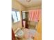 Tiled bathroom with a glass shower, pink towels, and a toilet next to the window at 2089 Avalon Dr, Laughlin, NV 89029