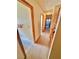 Carpeted hallway with oak cabinets, light colored walls and white trim at 2089 Avalon Dr, Laughlin, NV 89029