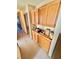 Long carpeted hallway with oak cabinets on the right at 2089 Avalon Dr, Laughlin, NV 89029