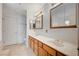 Bathroom featuring dual sinks, vanity, and large framed mirrors at 6990 W Richmar Ave, Las Vegas, NV 89178