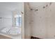 Bright bathroom featuring large soaking tub and tiled shower stall at 6990 W Richmar Ave, Las Vegas, NV 89178
