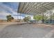 Gravel-covered storage area with a detached metal awning and various sheds at 6990 W Richmar Ave, Las Vegas, NV 89178