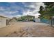 Exterior view of a large dirt lot with sheds, metal awning, and a shipping container at 6990 W Richmar Ave, Las Vegas, NV 89178