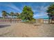 Exterior of a tree covered property with sheds and fencing at 6990 W Richmar Ave, Las Vegas, NV 89178