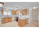 Bright kitchen with a window, white appliances, and a hanging rack at 6990 W Richmar Ave, Las Vegas, NV 89178