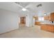 An open kitchen features ample counter space, bright lighting, and wood cabinets at 6990 W Richmar Ave, Las Vegas, NV 89178