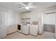Bright laundry room with white washer, dryer, sink, and cabinet storage at 6990 W Richmar Ave, Las Vegas, NV 89178