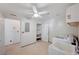 Functional laundry area with utility sink, washer, dryer hookups, and storage closet at 6990 W Richmar Ave, Las Vegas, NV 89178