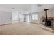 Open-concept living area with a cozy fireplace and sliding glass door to the backyard at 6990 W Richmar Ave, Las Vegas, NV 89178