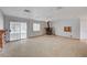 Spacious living room featuring a unique fireplace, sliding glass door, and neutral tones at 6990 W Richmar Ave, Las Vegas, NV 89178