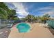Outdoor pool with chairs, surrounded by trees and a blue sky at 6990 W Richmar Ave, Las Vegas, NV 89178