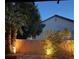 A tranquil backyard featuring ambient lighting and lush landscaping, perfect for evening relaxation at 6007 Turtle River Ave, Las Vegas, NV 89156