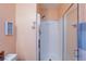 Close up of a bathroom shower with glass doors, featuring neutral tones and a shower head at 6007 Turtle River Ave, Las Vegas, NV 89156